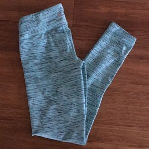 Teal, white, and black stretchy sport leggings.